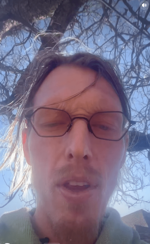 Man wearing glasses speaking into a camera.